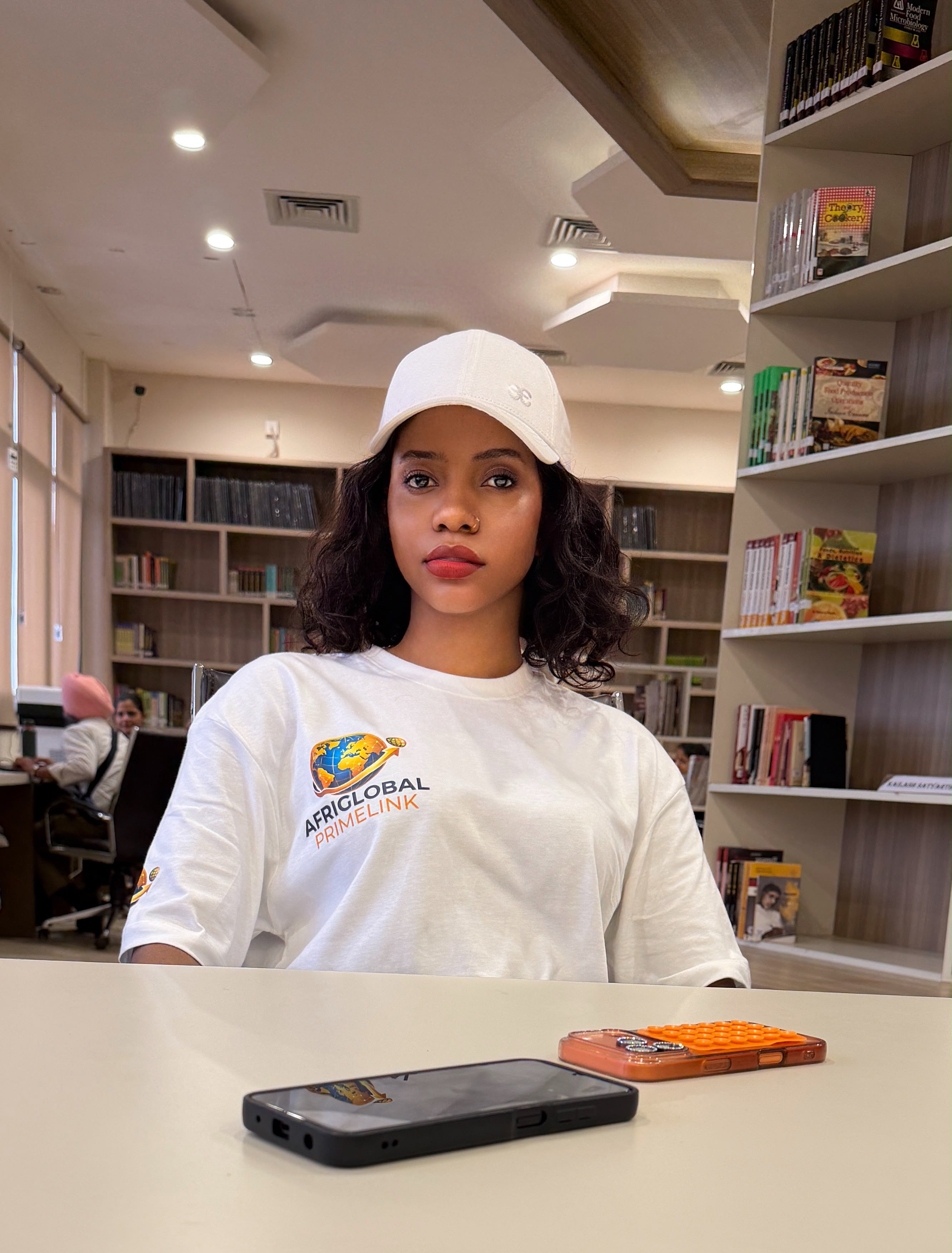 An AfriGlobal representative among the bookshelves of the CGC library