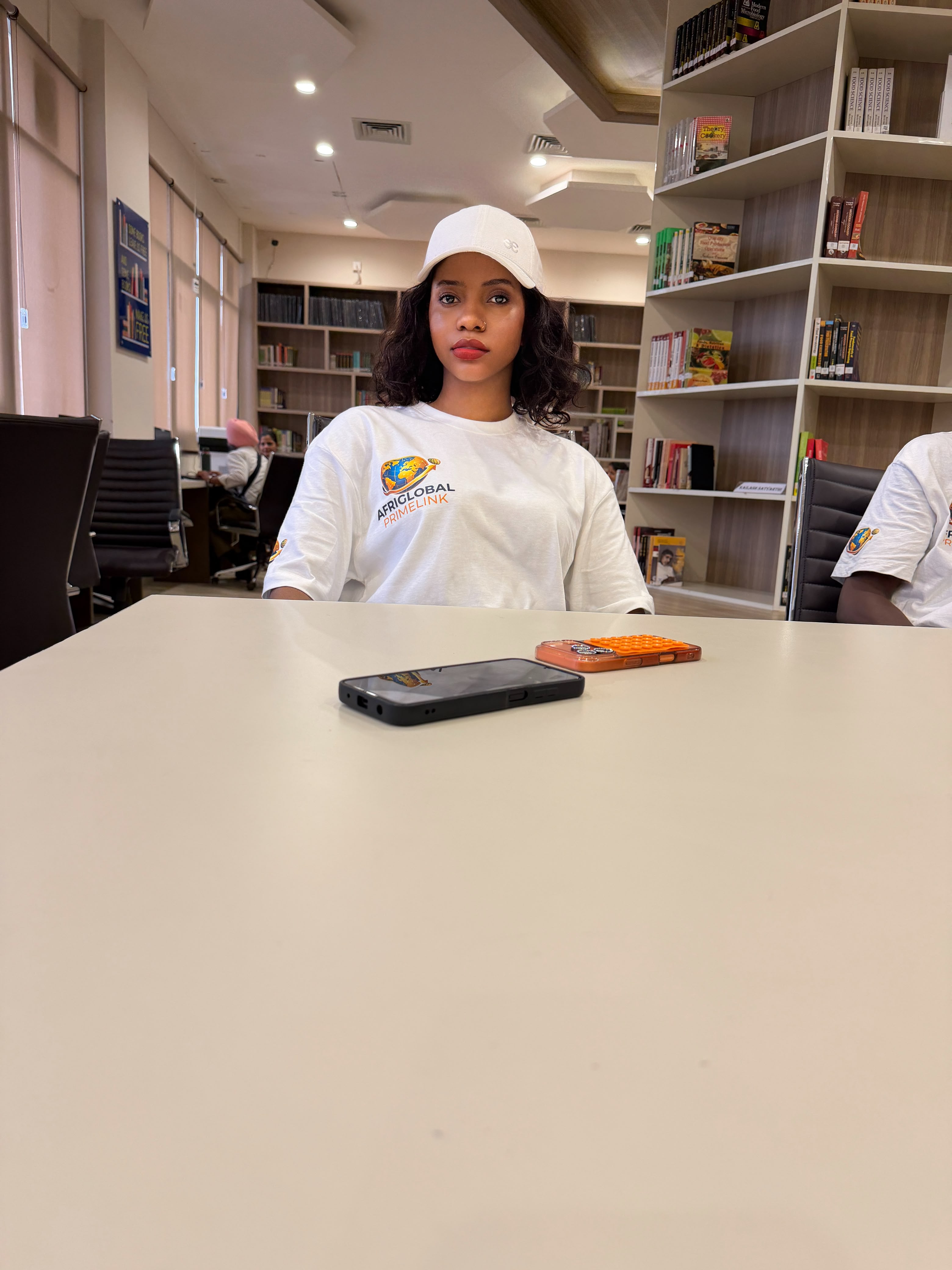 An AfriGlobal representative at a table in the CGC library
