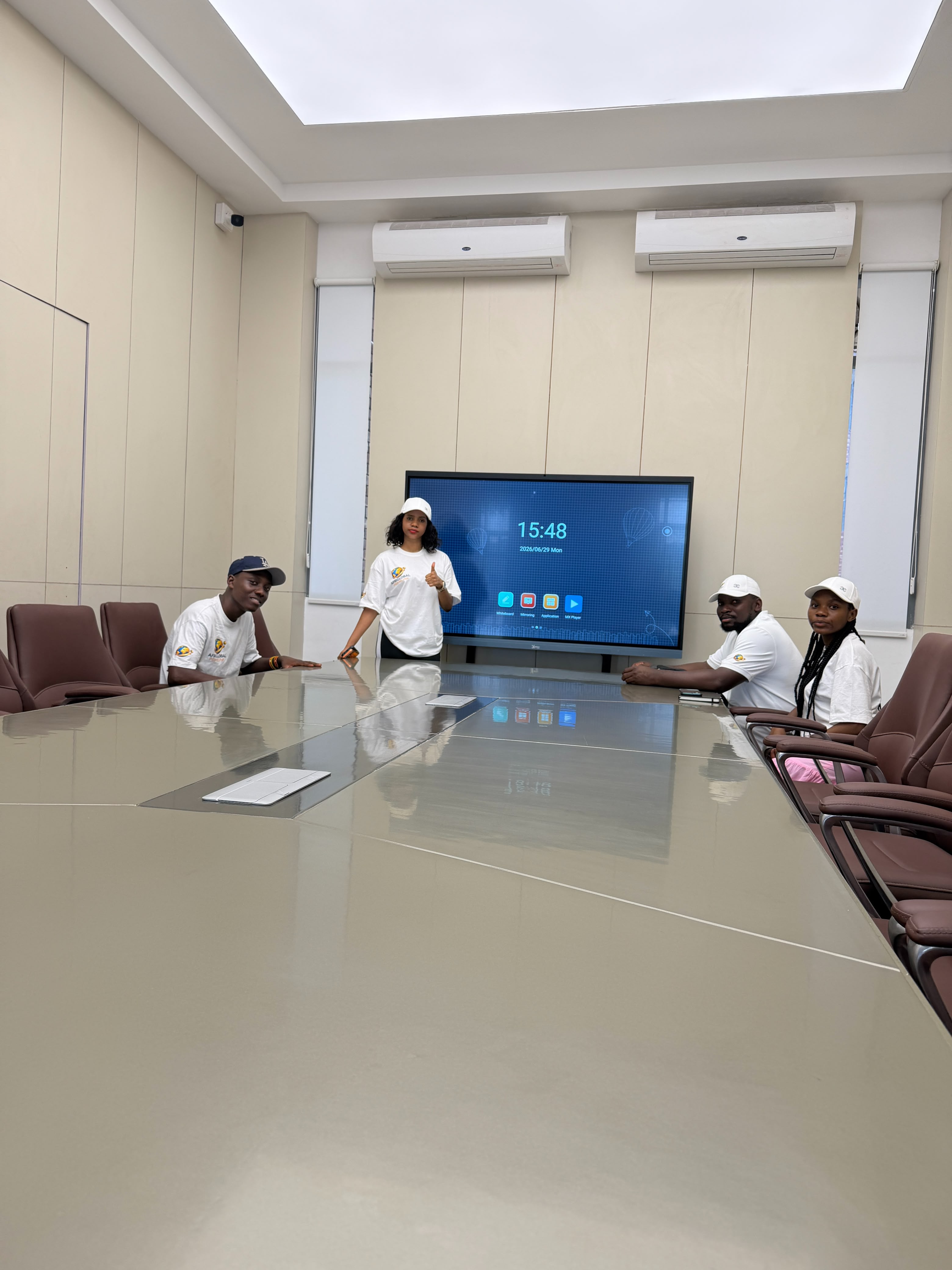 A meeting under way in a CGC boardroom with a large smart display