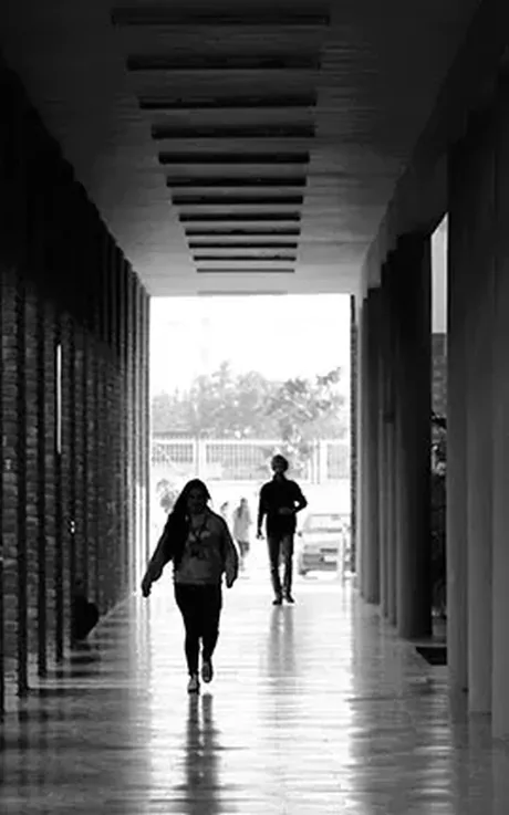 Students walking through a campus colonnade at Chandigarh University