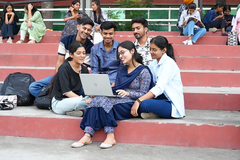 Students studying together on the campus steps at Rayat Bahra University